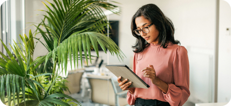 An entrepreneur uses a tablet to check her calendar