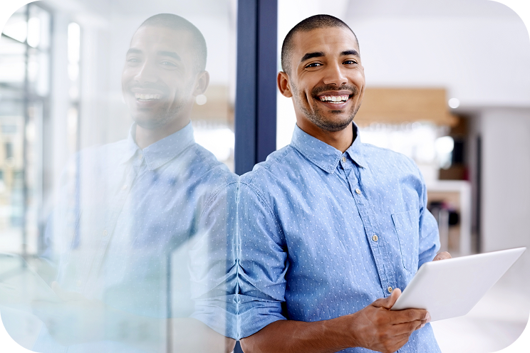 Person smiling and holding a tablet.