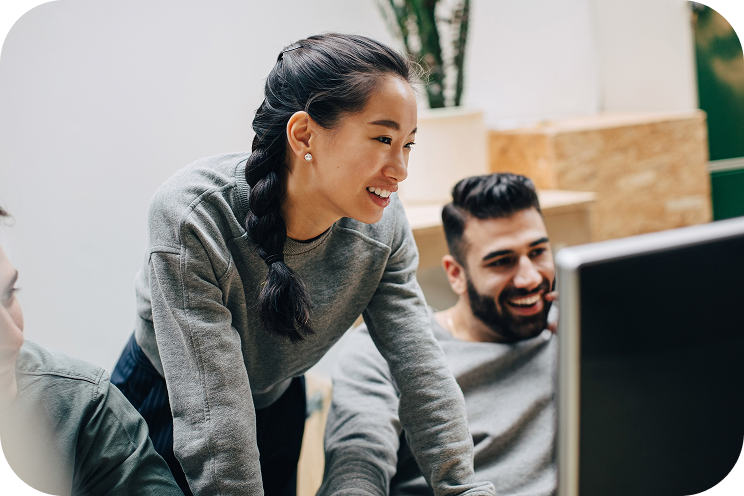 Two people looking at a computer.