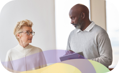 Two people looking at each other discussing work