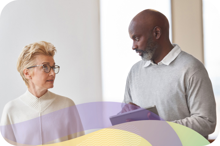 Two people in an office space engaging in conversation