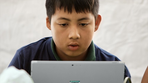 A boy looking at tablet