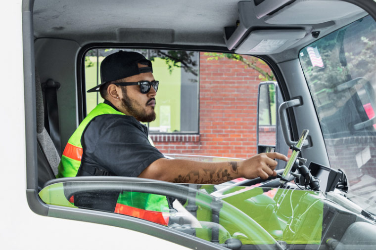 A truck driver navigates an urban environment