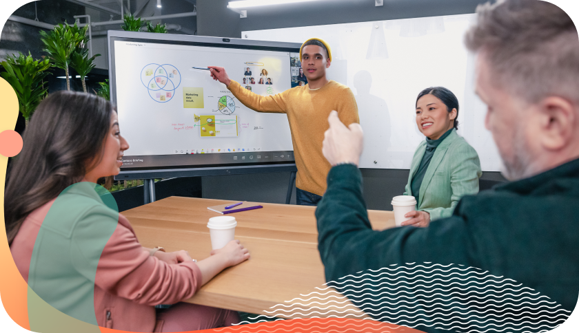 Colleagues use a whiteboard during a brainstorming session