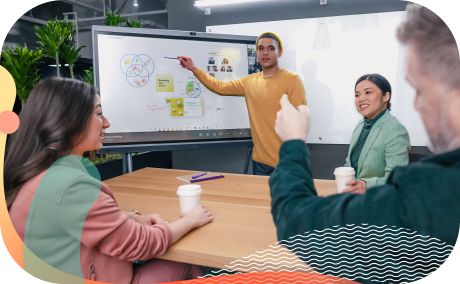 Colleagues use a whiteboard during a brainstorming session