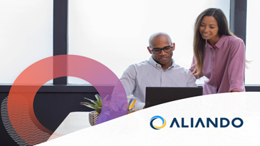 Two people looking at a laptop.