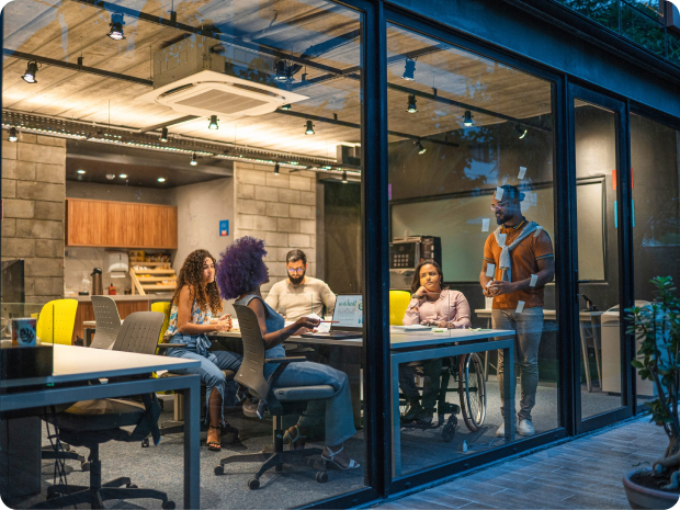 People in a glass-walled conference room