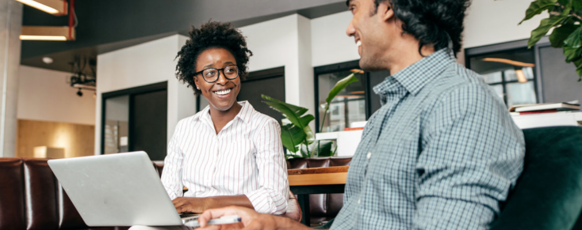 Two employees collaborate in an office setting.