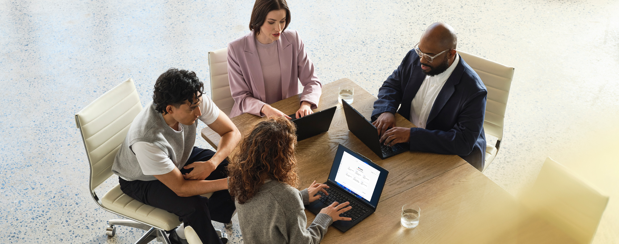A mixed-gender team collaborates in an office space.