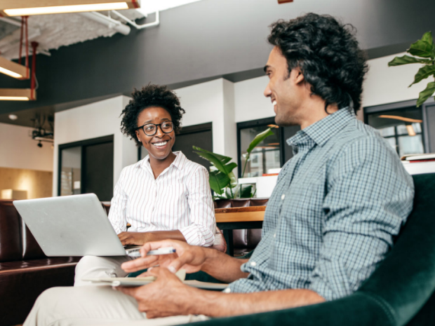 Two employees collaborate in an office setting