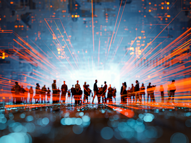 Futuristic cityscape with people silhouetted in the distance