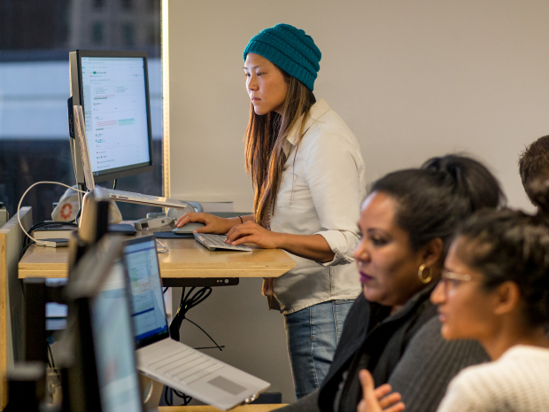 person working at a computer in an open space office