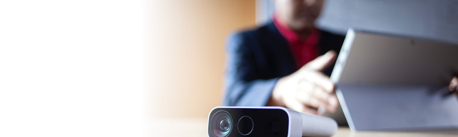 A man works on a mobile device at a desk