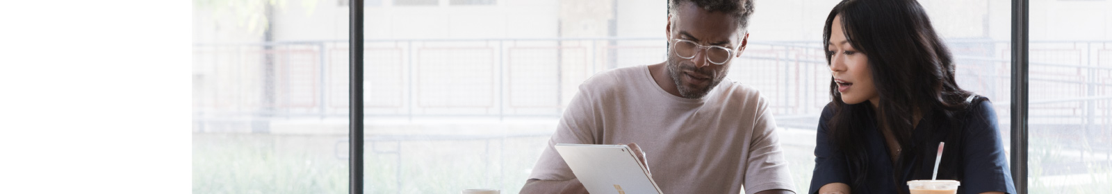Man and woman looking at a Microsoft Surface