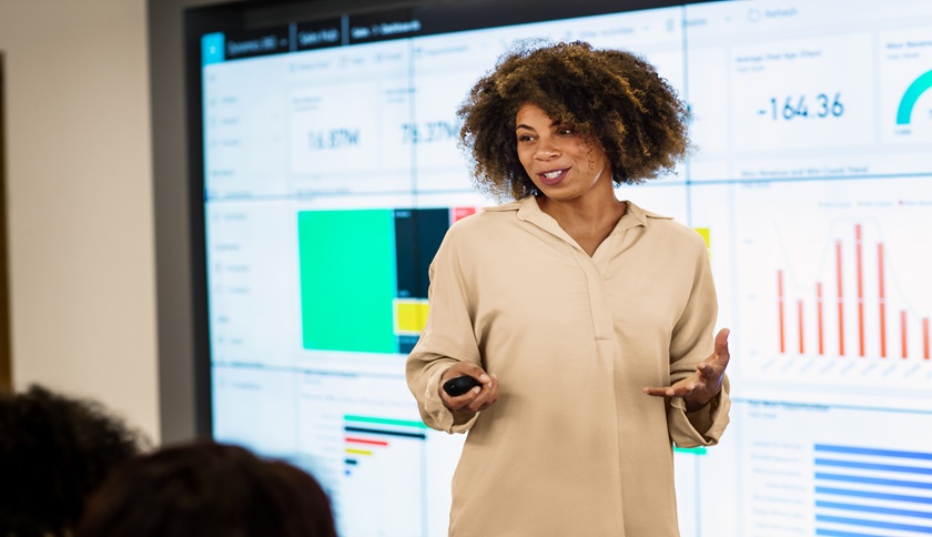 CEO presenting sales results to large group meeting