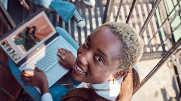 A young girl working on a presentation with her laptop