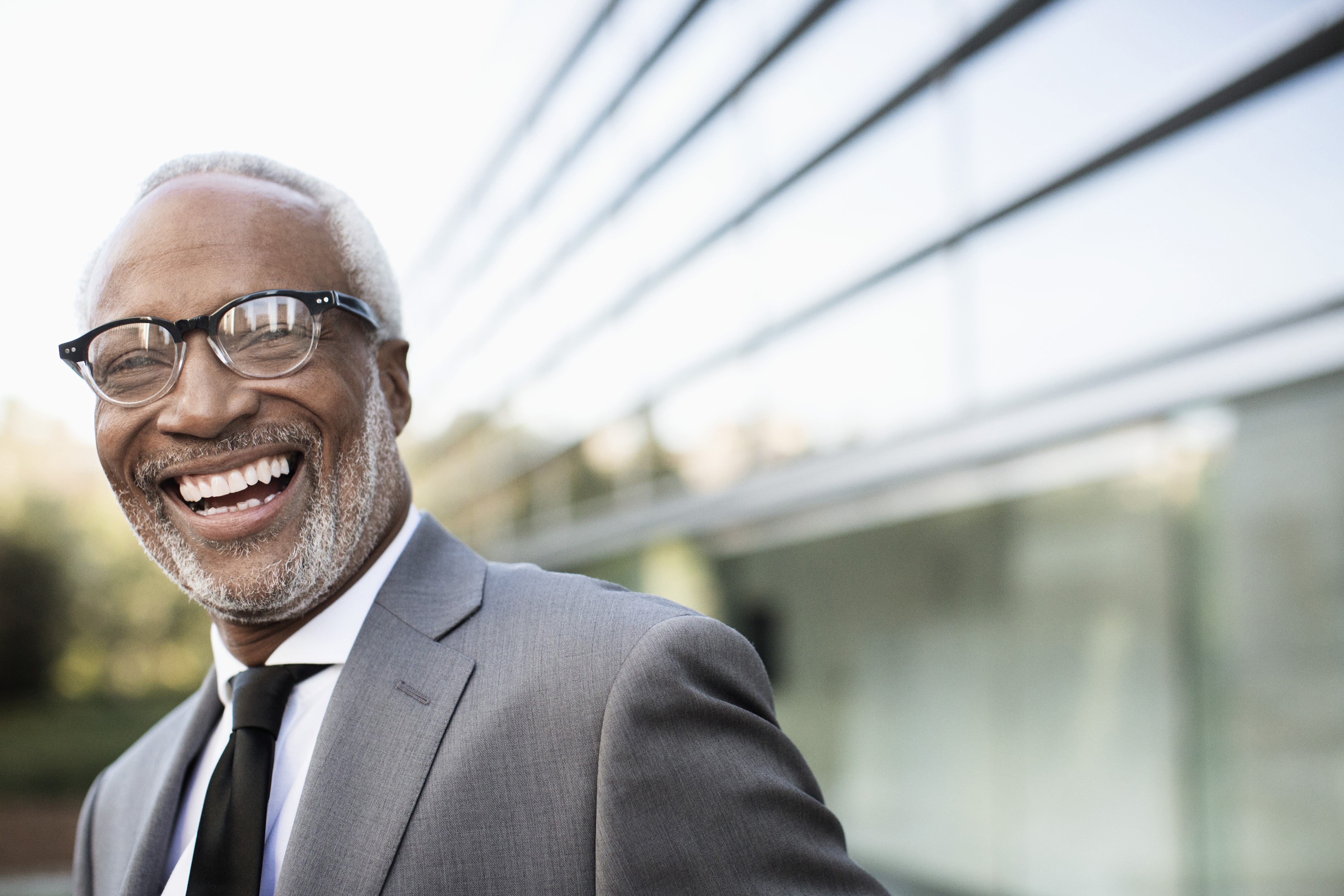 Black businessman laughing outdoors