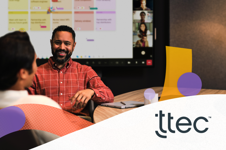 Two people sitting at a conference table.