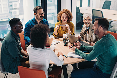 A group of people seated around a conference table