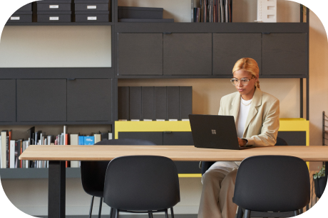 Person seated at a table with a laptop