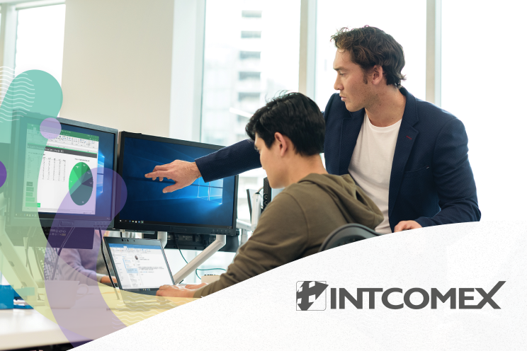 Two men collaborating at a desk in a modern office.