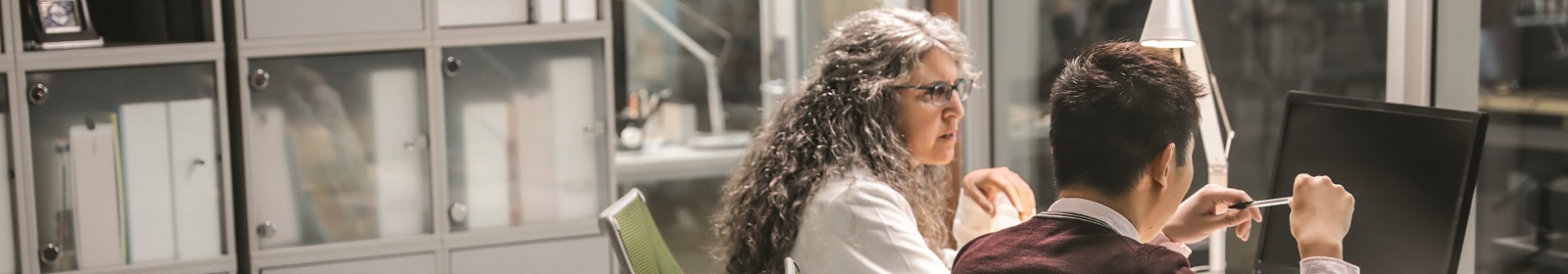 Healthcare administrators work together at a computer