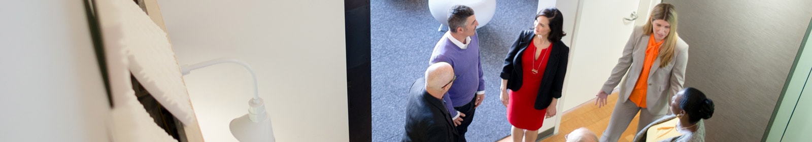 Angled shot of coworkers speaking after meeting