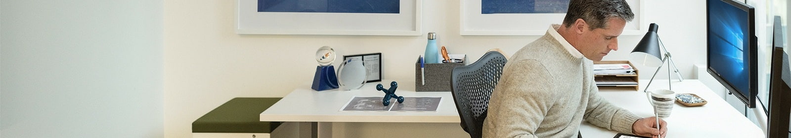 Man sitting at desk works on a tablet