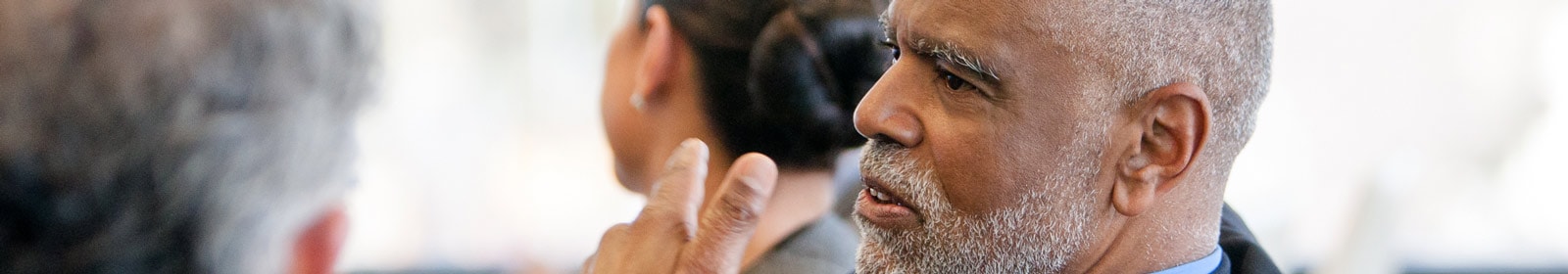 Man looking thoughtfully at coworker