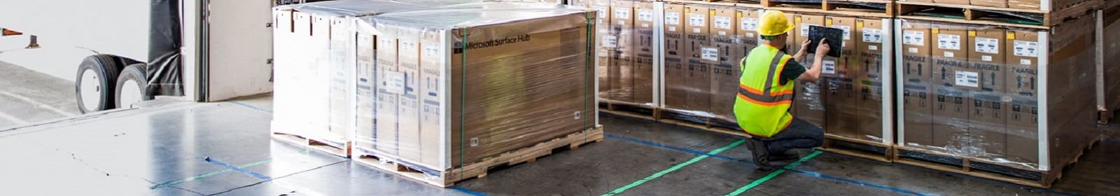 A man checks pallets in a warehouse