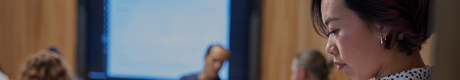 A woman working on a laptop in a security operations center