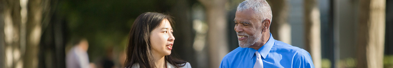 Two Coworkers walking outside and talking