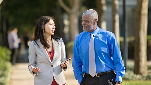 Coworkers talking and walking outside