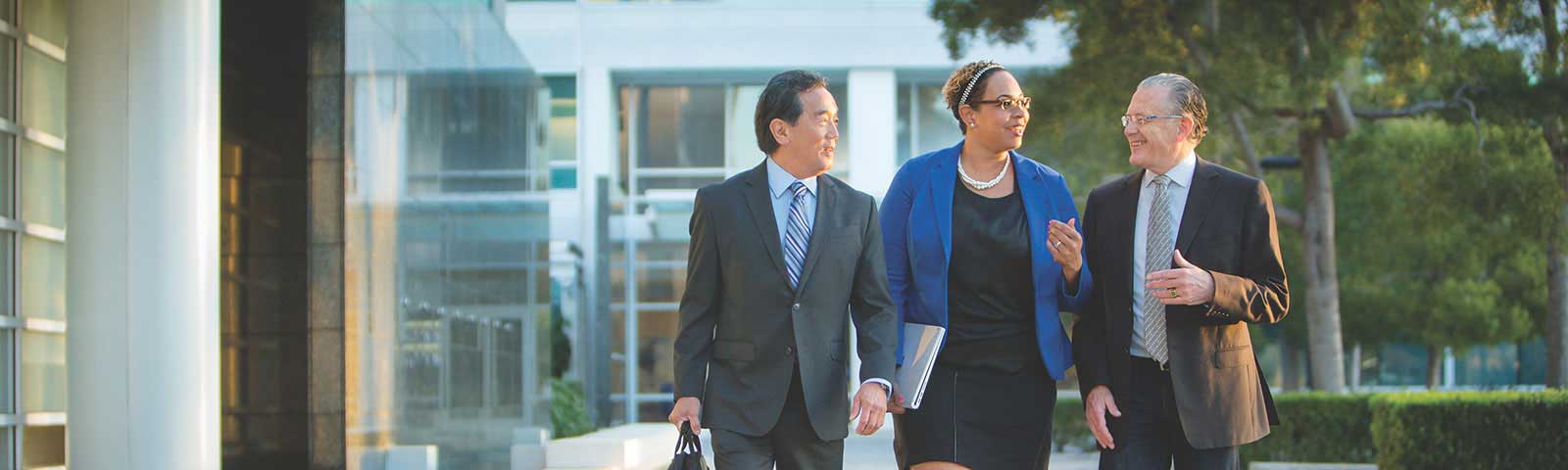 Three colleagues having a discussion outside