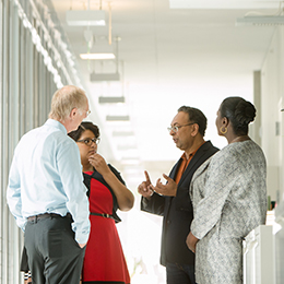 Coworkers having a discussion in hallway