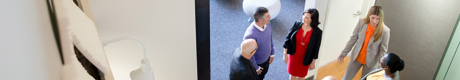 Coworkers talking outside of meeting room