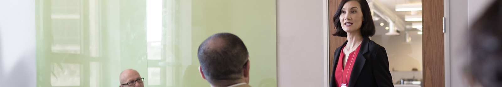 Three people having a meeting in a hallway