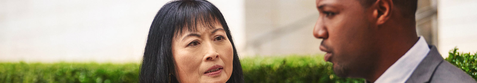 A woman and man discuss a new idea in a courtyard