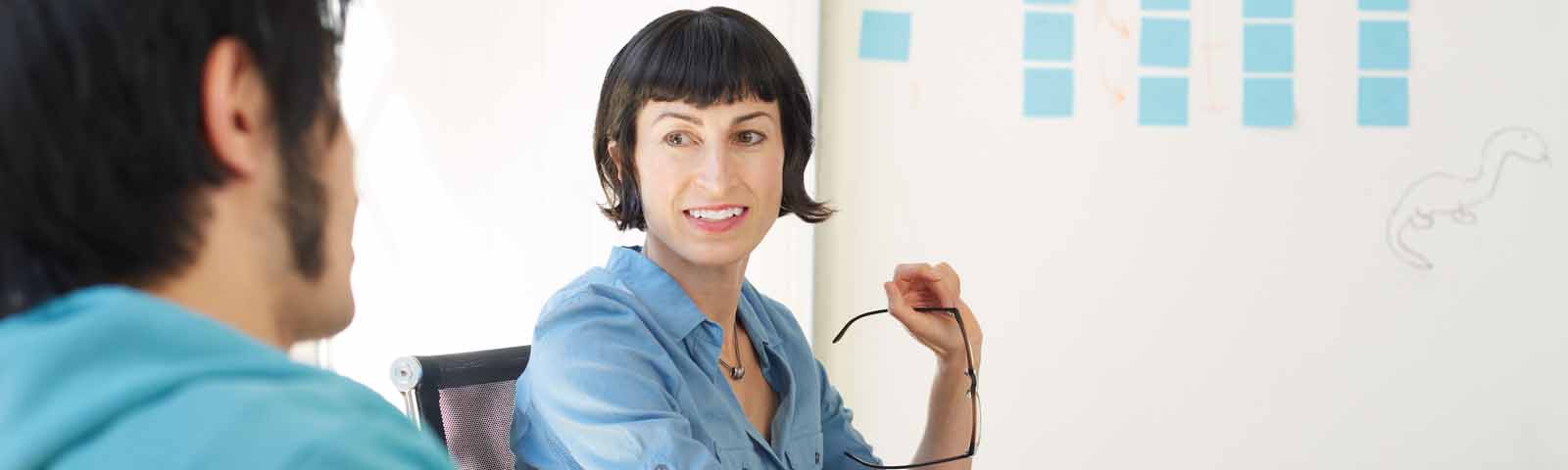 Two men in shop looking at a computer screen
