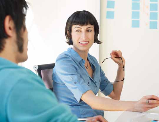Two men in shop looking at a computer screen