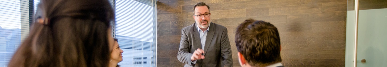Man presenting to coworkers in conference room