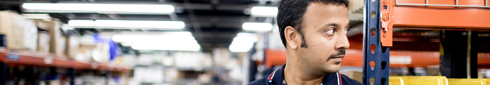 Man on warehouse floor with tablet