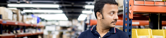 Man on warehouse floor with tablet