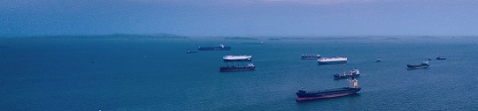 Cargo ships wait offshore to dock