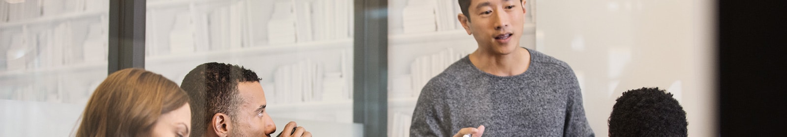 Man presenting to coworkers in conference room