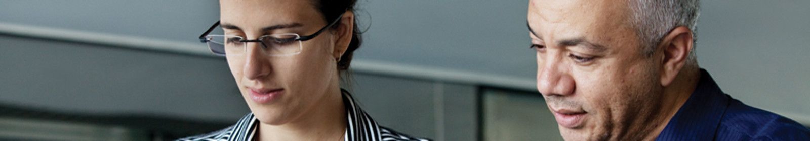 Two colleagues review a document