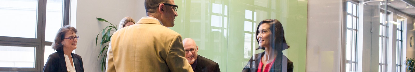 Business people greeting each other in conference room