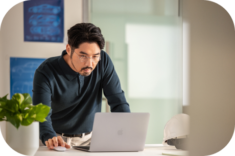A person working on a laptop in an office.