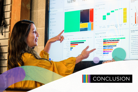 A person reviewing data charts being projected on a screen.