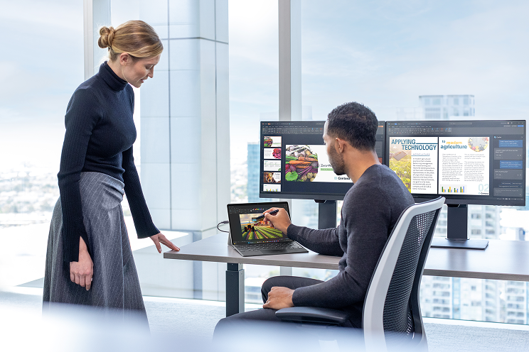 Two people looking at a tablet.